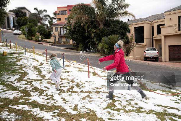 People enjoy the snow after a snowfall in Johannesburg, South Africa on July 10, 2023.