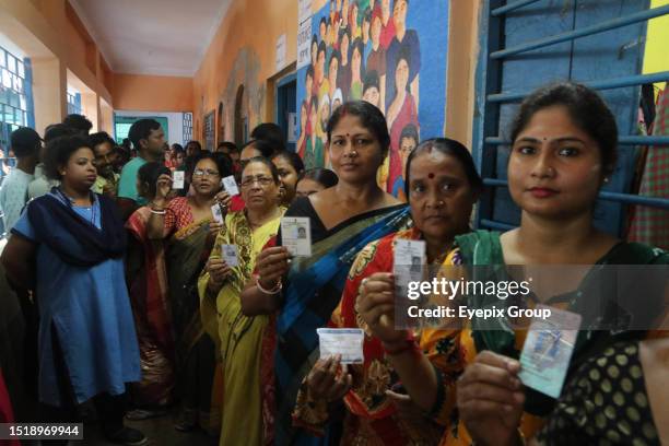 July 08 Howrah,India: Muslim women showing the Voter ID cards queue at a polling station to cast their vote in West Bengal's 'Panchayat' or local...