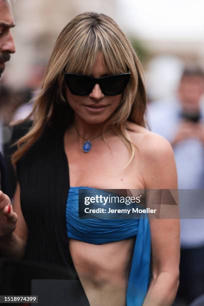 Heidi Klum seen outside Jean Paul Gaultier show wearing black sunnies, blue diamond necklace and blue and black Jean Paul Gaultier dress during the...