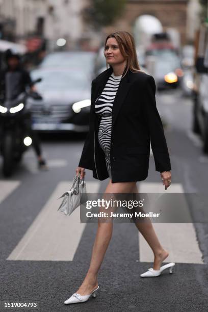 Eugenie Trochu seen outside Jean Paul Gaultier show wearing black blazer, Zebra striped slim dress and white slip on heels during the Haute Couture...