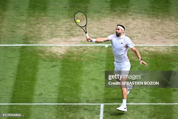 Bulgaria's Grigor Dimitrov returns the ball to Denmark's Holger Rune during their men's singles tennis match on the eighth day of the 2023 Wimbledon...