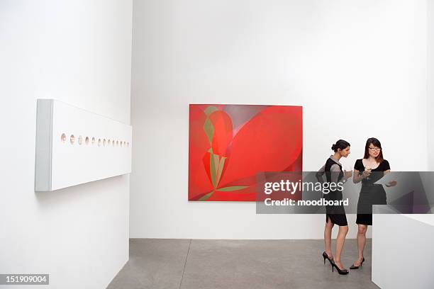 two woman standing next to wall paintings - chinese museum stock pictures, royalty-free photos & images