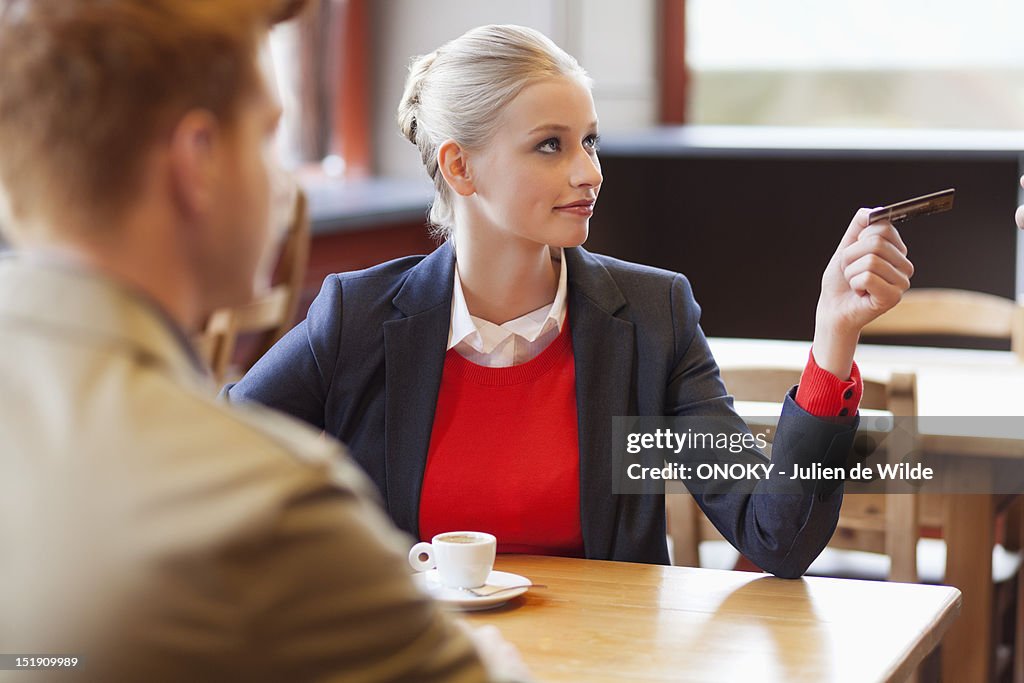 Woman paying by credit card in a restaurant