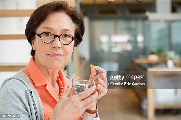 woman taking medicine - moving activity stock pictures, royalty-free photos & images