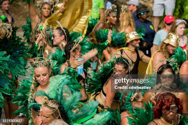 costumed group of women dancing in the street, carnival, st. john, 2023 - cruz bay harbor stock pictures, royalty-free photos & images