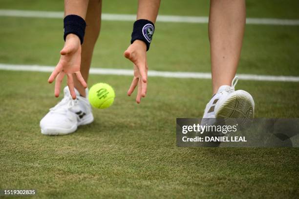 Ball boy picks up a tennis ball during the men's singles tennis match US player Christopher Eubanks and Greece's Stefanos Tsitsipas on the eighth day...