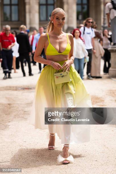 Leonie Hanne wears a neon green bralette, neon green and cream degradé maxi skirt, Jimmy Choo sandals and yellow Hermes bag, outside Elie Saab,...