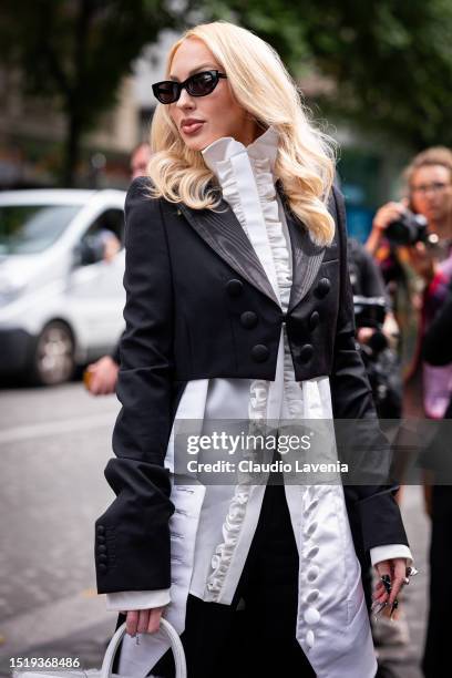 Christine Quinn wears a white ruffle shirt, black cropped blazer, black sunglasses and white bag, outside Viktor & Rolf, during the Haute Couture...