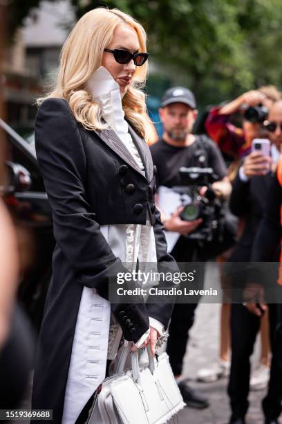 Christine Quinn wears a white ruffle shirt, black cropped blazer, black sunglasses and white bag, outside Viktor & Rolf, during the Haute Couture...