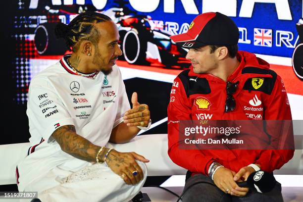 Lewis Hamilton of Great Britain and Mercedes and Charles Leclerc of Monaco and Ferrari talk in the Drivers Press Conference during previews ahead of...