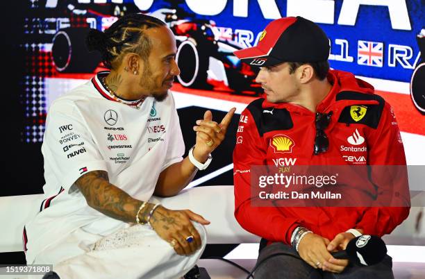 Lewis Hamilton of Great Britain and Mercedes and Charles Leclerc of Monaco and Ferrari talk in the Drivers Press Conference during previews ahead of...