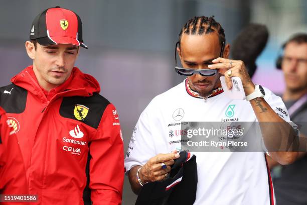 Charles Leclerc of Monaco and Ferrari and Lewis Hamilton of Great Britain and Mercedes talk in the Paddock during previews ahead of the F1 Grand Prix...