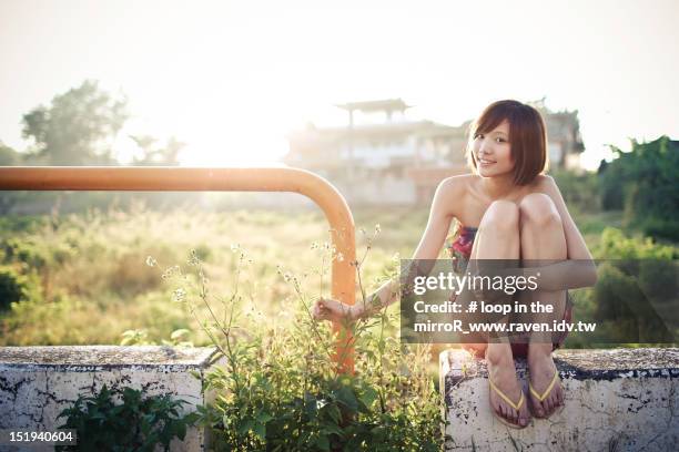 girl in sunlight - hugging knees stock pictures, royalty-free photos & images