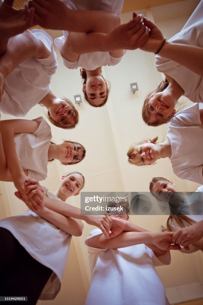 High school students in gym holding hands