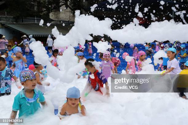 Children play with bubbles to cool off at a kindergarten on July 6, 2023 in Rongjiang County, Qiandongnan Miao and Dong Autonomous Prefecture,...