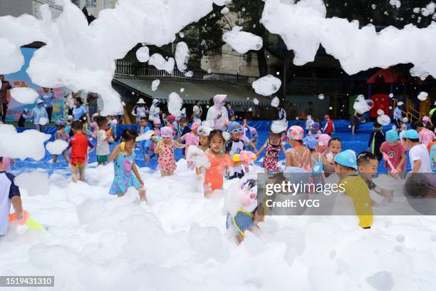 Children play with bubbles to cool off at a kindergarten on July 6, 2023 in Rongjiang County, Qiandongnan Miao and Dong Autonomous Prefecture,...