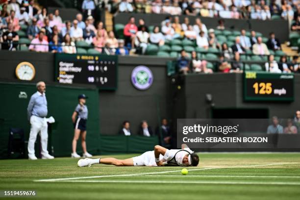 Bulgaria's Grigor Dimitrov falls on the court as he returns the ball to Denmark's Holger Rune during their men's singles tennis match on the eighth...