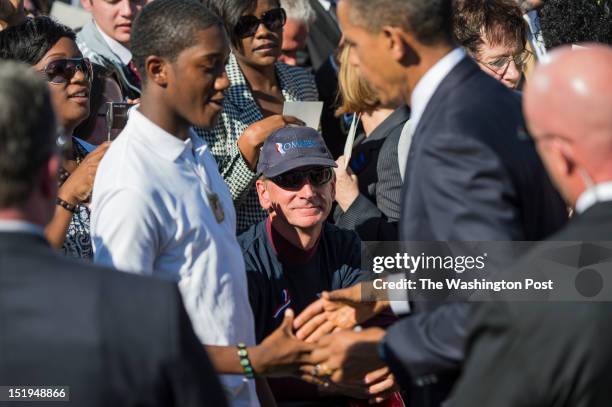 President Barack Obama greet family members and survivors following a private ceremony on the 11th anniversary of the 9/11 attacks at the Pentagon in...