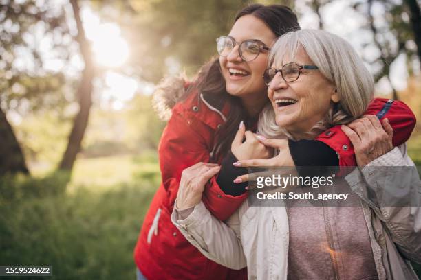 giovane donna con la nonna in natura - family hiking in spring outdoors foto e immagini stock