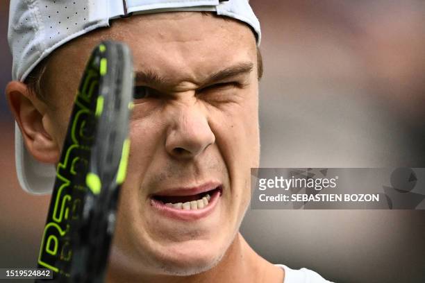 Denmark's Holger Rune reacts as he plays against Bulgaria's Grigor Dimitrov during their men's singles tennis match on the eighth day of the 2023...