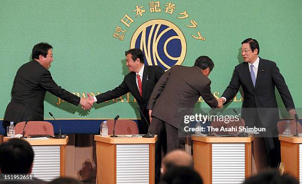 Japanese Prime Minister and the leader of the Democratic Party of Japan Yoshihiko Noda shakes hands with Kazuhiro Haraguchi while Hirotaka Akamatsu...