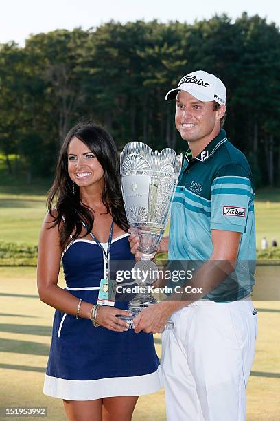 Nick Watney and his wife Amber celebrate with the trophy after NIck won the tournament following the final round of The Barclays at the Black Course...