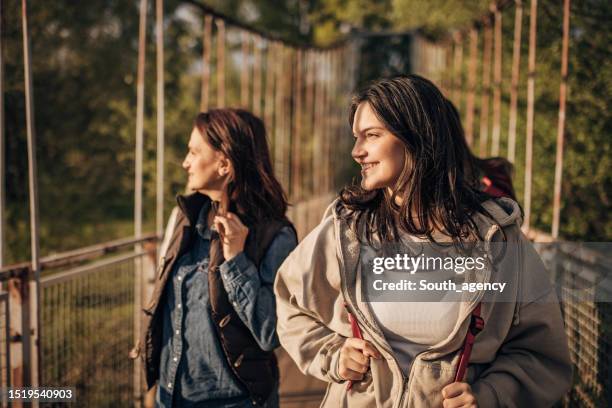 mother and daughter on a small bridge - teen backpacker stock pictures, royalty-free photos & images
