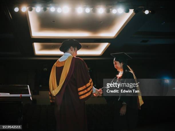 convocation ceremony asian graduation university female student handshake with dean on auditorium stage - assembly room stock pictures, royalty-free photos & images