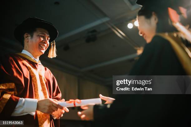 convocation ceremony asian dean hand over graduation university student graduation scroll on auditorium stage - dean stock pictures, royalty-free photos & images