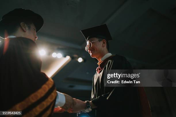 convocation ceremony asian dean hand over graduation university student graduation scroll on auditorium stage - dean stock pictures, royalty-free photos & images