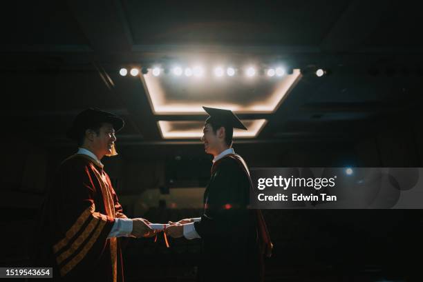 convocation ceremony asian dean hand over graduation university student graduation scroll on auditorium stage - dean stock pictures, royalty-free photos & images