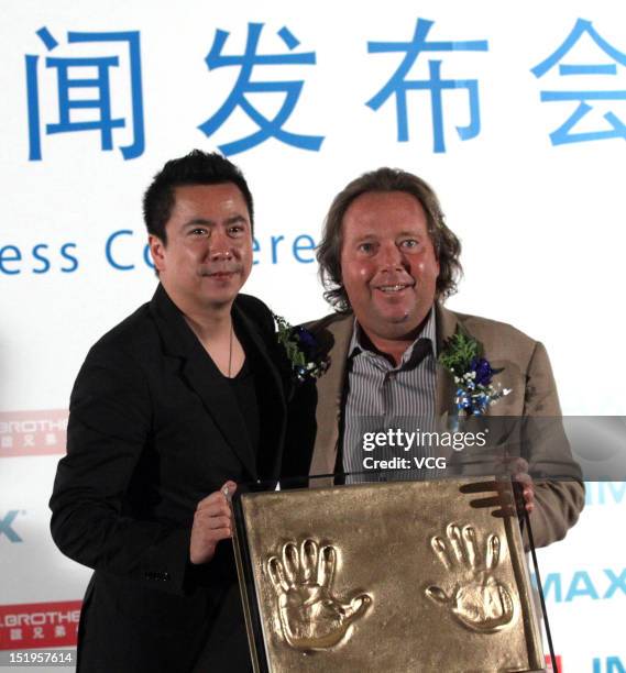 Huayi Brothers Media President Wang Zhonglei and IMAX CEO Richard L. Gelfond pose with imprints of their hands during a signing ceremony on September...