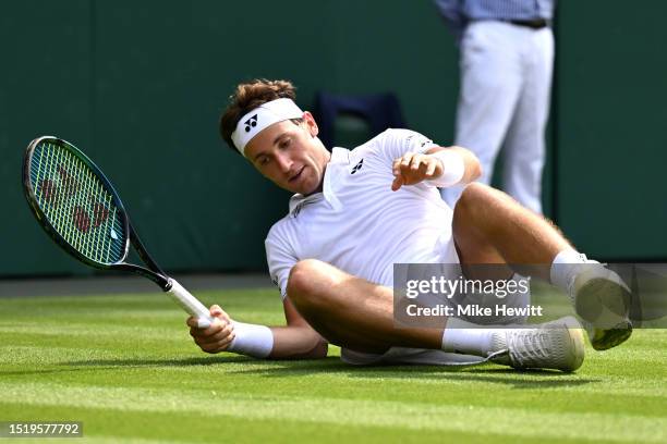 Casper Ruud of Norway falls against Liam Broady of Great Britain in the Men's Singles second round match during day four of The Championships...