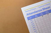 Close up view of student attendance sheet. An attendance sheet is a document used to record the presence or absence of individuals.