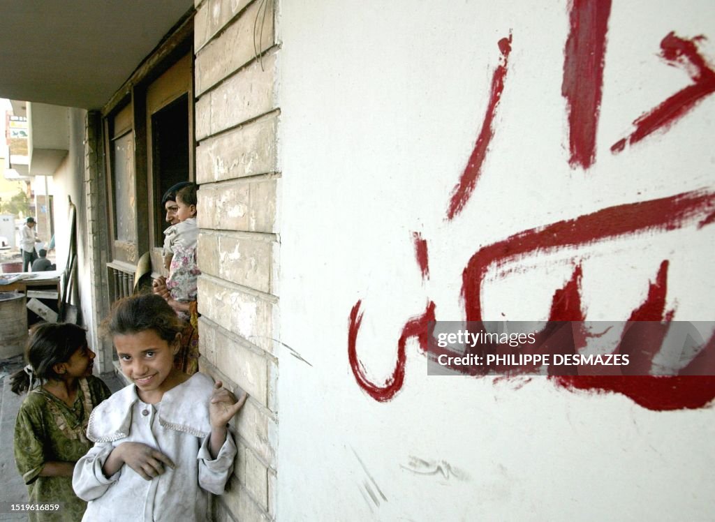 House Rumble Iraq An Iraqi family stands in the doorway of their new home after taking ...