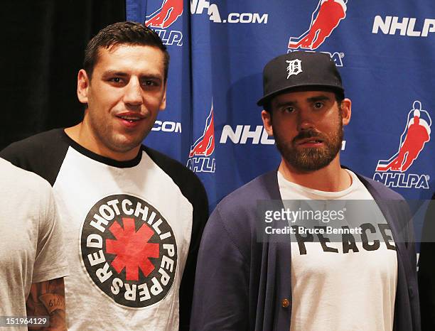 Milan Lucic of the Boston Bruins and Henrik Zetterberg of the Detroit Red Wings wait on the stage for the start of the NHLPA press conference at...