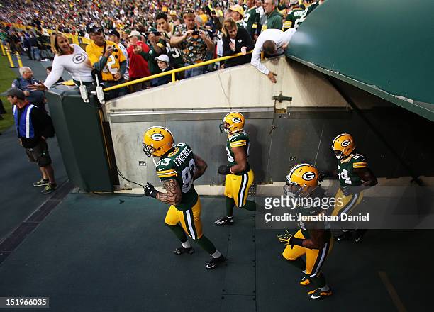Tight end Tom Crabtree of the Green Bay Packers leads teammates onto the field for warm-ups prior to their game against the Chicago Bears at Lambeau...