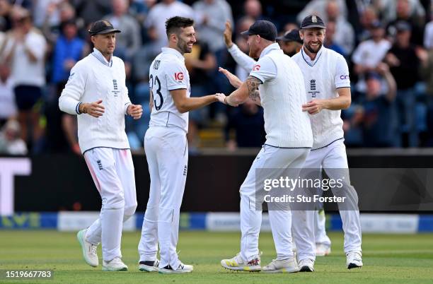 Mark Wood of England celebrates with Ben Stokes, Joe Root and Chris Woakes after dismissing Alex Carey of Australia during Day One of the LV=...