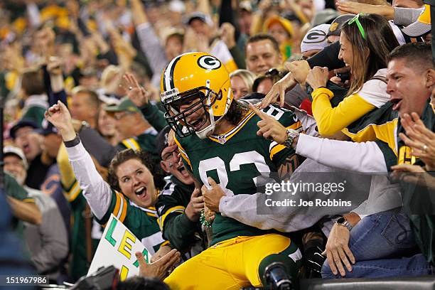 Tom Crabtree of the Green Bay Packers celebrates with fans after a 27-yard touchdown reception on a fake field goal during first half play against...