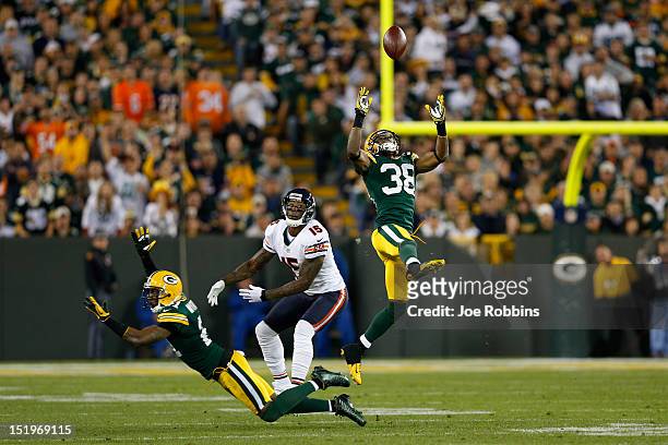 Tramon Williams of the Green Bay Packers intercepts a pass intended for Brandon Marshall of the Chicago Bears in the second half of the game at...