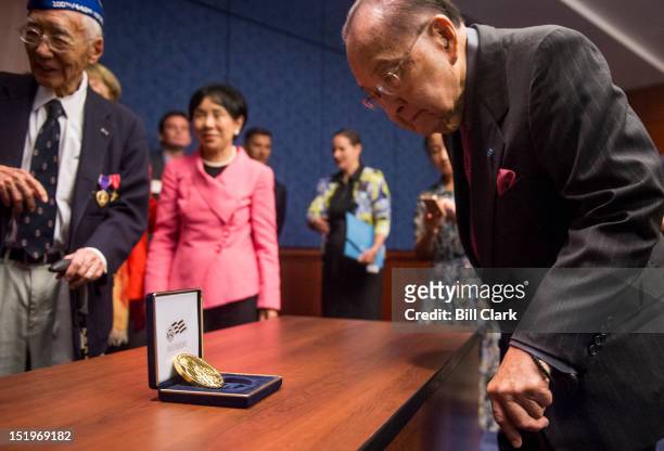 Medal of Honor recipient Sen. Daniel Inouye, D-Hawaii, takes a look at the Congressional Gold Medal Awarded to Japanese American World War II...