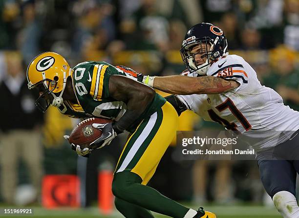 Donald Driver of the Green Bay Packers catches a touchdown pass in front of Chris Conte of the Chicago Bears at Lambeau Field on September 13, 2012...