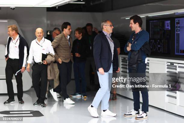 Stefano Domenicali, CEO of the Formula One Group, talks with Joseph Kosinski, director of the upcoming Formula One movie, Apex, in the Paddock during...