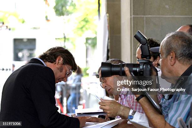 Filmmaker Alvaro Longoria signs autographs for fans at the "Sons Of The Clouds: The Last Colony" premiere during the 2012 Toronto International Film...