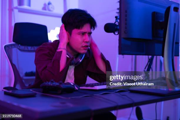 young man playing game online, gamer controlling joystick for video game. - mental illness stock pictures, royalty-free photos & images