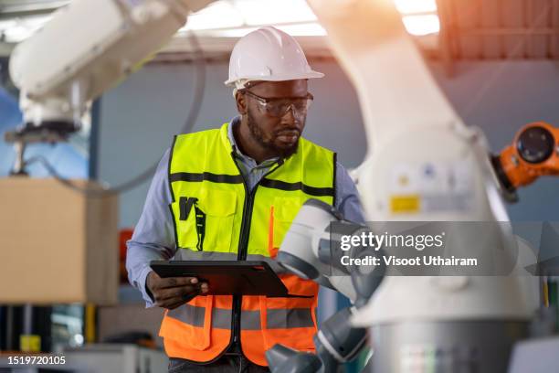 industrial engineer or technician worker in hard helmet checking on robotic arm machine. - applied mathematics stock pictures, royalty-free photos & images