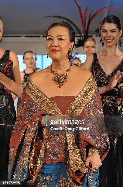 Fashion designer Sue Wong takes a bow at the end of her 2012 "Autumn Sonata" collection Fashion Show that was a part of the sixth annual Designer...