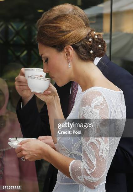 Catherine, Duchess of Cambridge drinks tea at the British High Commission on day 4 of Prince William, Duke of Cambridge and Catherine, Duchess of...