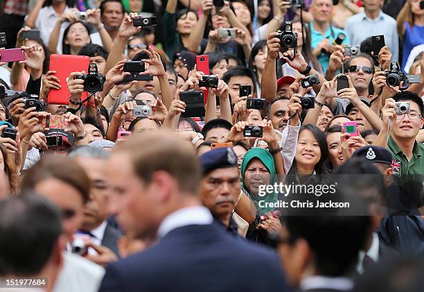 Members of the public take photographs as Catherine, Duchess of Cambridge and Prince William, Duke of Cambridge attend a cultural event on day 4 of...