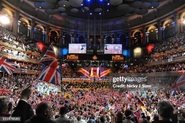 The audience wave flags and sing along as Jiri Belhlavek conducts the BBC Symphony Orchestra and the BBC Symphony Choir on stage during the climax of...